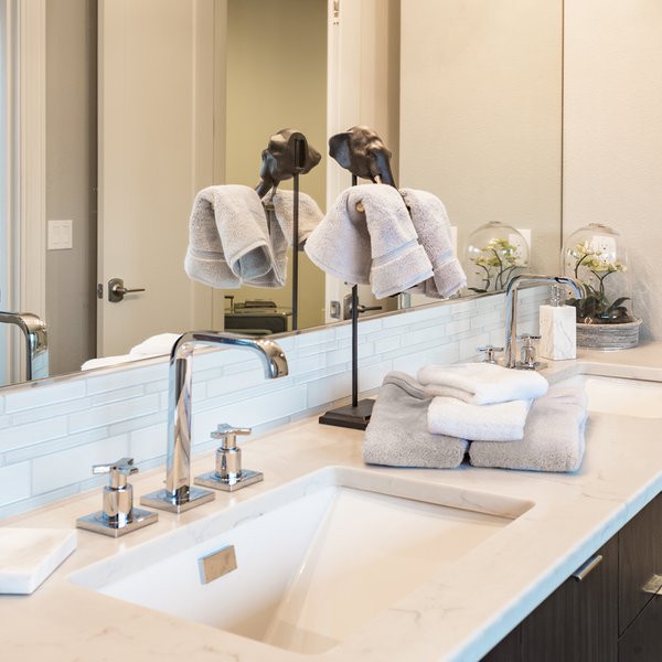 Double sinks and counter decorated with towels